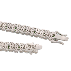 Sterling silver bracelet featuring oval green Chrome Diopside gemstones, showcasing intricate links and a secure clasp.