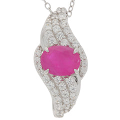 Elegant oval red ruby sterling silver pendant with diamond accents, radiating luxury and style.