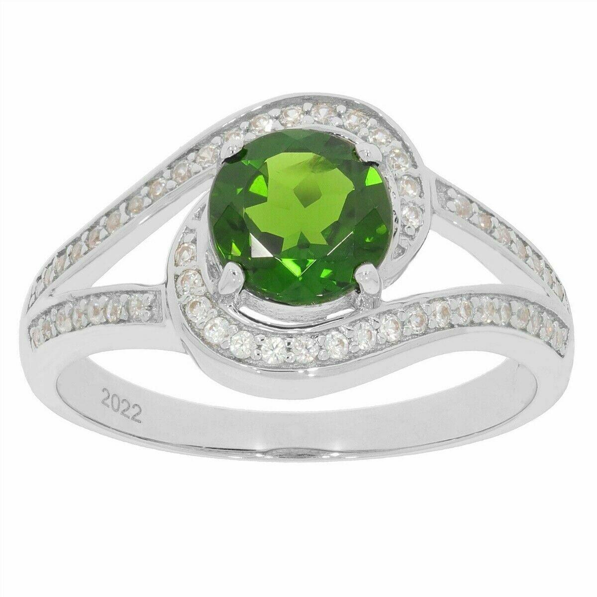 Custom sterling silver ring with round green gemstone and sparkling accents, showcased on a white background.