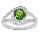 Custom sterling silver ring with round green gemstone and sparkling accents, showcased on a white background.