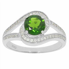 Custom sterling silver ring with round green gemstone and sparkling accents, showcased on a white background.