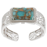 Elegant blue turquoise sterling silver bangle with intricate design and sparkling accent.