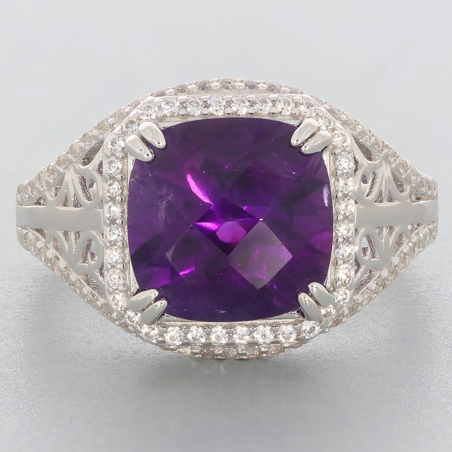 Emerald purple amethyst sterling silver ring with accent gemstones, showcasing a sparkling purple stone in an elegant design.