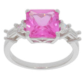 Emerald cut pink sapphire ring with sparkling accent stones set in sterling silver for elegance and style.