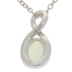 Oval green peridot pendant in polished 14K yellow gold setting with diamond accent, elegant necklace design.