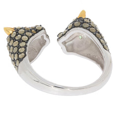 Unique silver ring with black and gold accents, featuring a playful cat design and sparkling gemstone details.