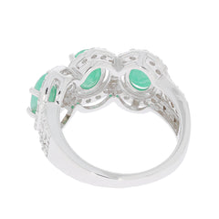 Oval green emerald sterling silver ring showcasing elegant design and sparkling accent on a classic setting.