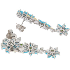 Blue turquoise sterling silver earrings with floral design and sparkling accents, perfect for elegant occasions.