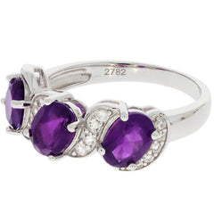 Oval purple amethyst sterling silver ring with moissanite accents, showcasing elegant three-stone design.