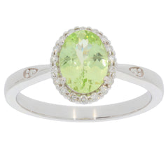Green Peridot ring in 14K white gold with diamond accents, showcasing an oval gemstone centerpiece and elegant design.