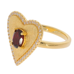 Heart-shaped ring in gold featuring an oval red garnet centerpiece and sparkling accents, ideal for elegant occasions.