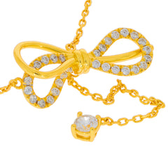 Elegant yellow gold necklace with a bow design and sparkling rhinestones, perfect for adding glamour to any outfit.