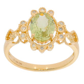 Oval green peridot 14K yellow gold ring with diamond accent, featuring an intricate floral design.