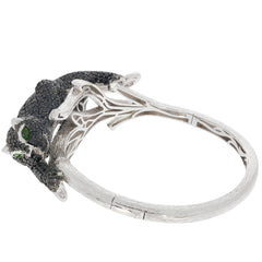 Elegant silver bracelet featuring a black panther design with sparkling green gemstones.