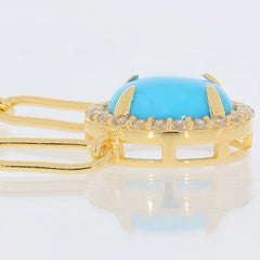 Elegant blue turquoise gemstone set in gold, showcasing intricate details of the sterling silver necklace.