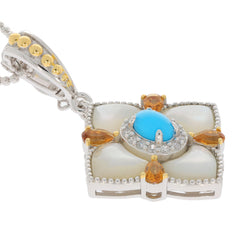 Blue turquoise sterling silver pendant with golden accents and sparkling gemstones, elegant jewelry piece.