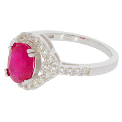 Oval red ruby sterling silver ring with accent stones, showcasing elegance and luxury.