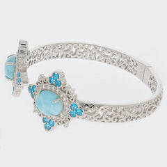 Oval blue Larimar Pectolite sterling silver bracelet with topaz accents, featuring an intricate design.