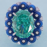 Cushion green moissanite sterling silver ring with blue accent gemstones, showcasing luxury and elegance.