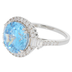 Round blue topaz sterling silver ring with sparkling accents, showcasing elegance and luxury.
