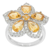 Elegant flower-shaped ring featuring pear yellow gemstones and sparkling accents in sterling silver.
