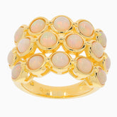 Elegant gold ring featuring multiple white opal gemstones, perfect for adding luxury to any jewelry collection.