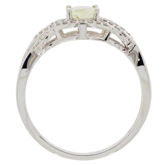 Elegant 14K white gold ring featuring a green peridot gemstone, showcasing intricate design and diamond accents.