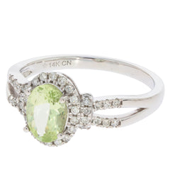 14K white gold ring featuring a green peridot gemstone surrounded by sparkling diamond accents.