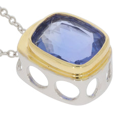 Blue Tanzanite sterling silver pendant with golden accents, featuring a large, sparkling gemstone on a delicate chain.