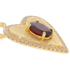 Oval red garnet heart pendant set in gold with sparkling moissanite accents, luxury jewelry piece for elegant style.