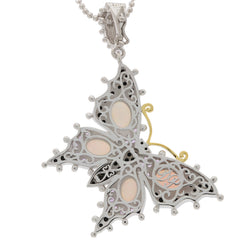 Elegant butterfly pendant in silver with opal accents, showcasing intricate filigree design and delicate details.