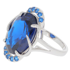 Oval blue sapphire sterling silver ring with accent stones, showcasing elegant design and vibrant color.