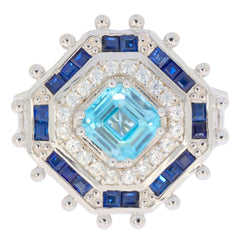 Emerald blue topaz sterling silver ring with sparkling gemstones, elegant design for luxury jewelry collection.