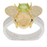 Elegant floral-inspired ring featuring green Peridot, opal, and sparkling accents in sterling silver and gold.