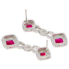Cushion red ruby sterling silver earrings showcasing elegant design and sparkling gemstones.