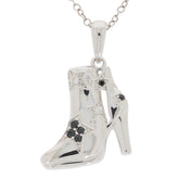 Stylish silver pendant in the shape of a high-heeled boot, adorned with black diamonds and sparkling accents.