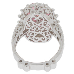 Elegant pink sapphire sterling silver ring with intricate design and sparkling gemstone accent.
