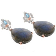 Elegant pear-shaped smoky quartz earrings with topaz accent, set in sterling silver, perfect for sophisticated style.