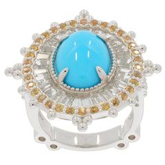 Oval blue turquoise sterling silver ring with sapphire accent, showcasing a vibrant gemstone and elegant design.