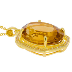 Oval yellow citrine pendant in sterling silver setting with accent stones, showcasing elegance and luxury.