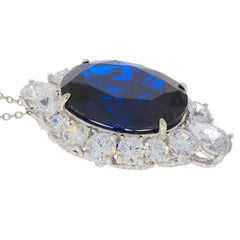 Oval blue sapphire sterling silver pendant with cubic zirconia accents, radiating elegance and luxury.