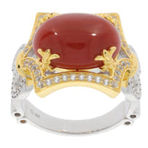Elegant oval red coral sterling silver ring with sparkling accents and gold details, perfect for sophisticated style.