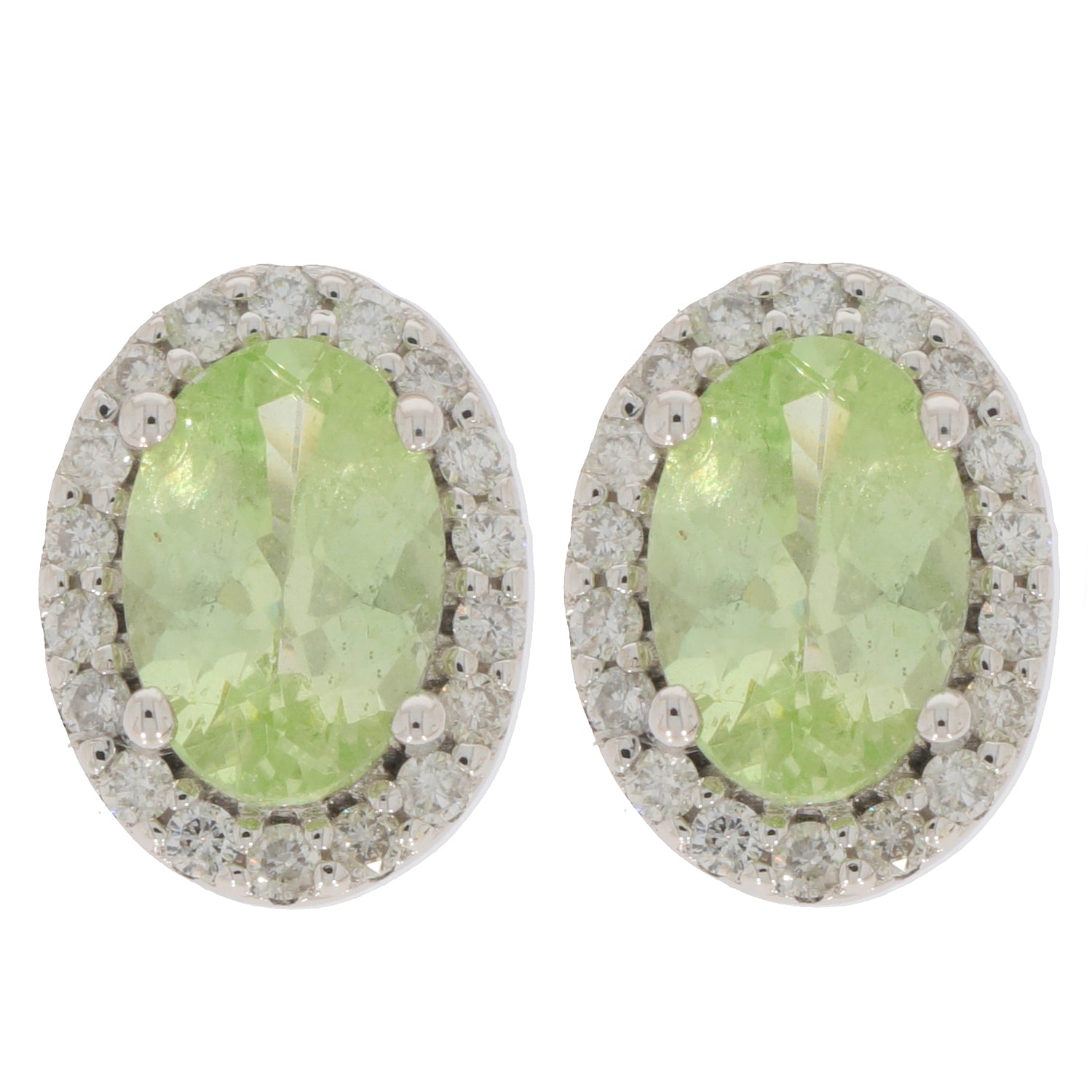 Oval green peridot earrings in 14K white gold with diamond accents, radiating elegance and luxury.