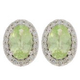 Oval green peridot earrings in 14K white gold with diamond accents, radiating elegance and luxury.