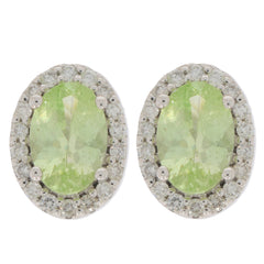 Oval green peridot earrings in 14K white gold with diamond accents, radiating elegance and luxury.