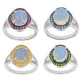 Four elegant sterling silver rings featuring oval white opals with colorful gemstone accents in purple, blue, yellow, and green.
