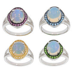 Four elegant sterling silver rings featuring oval white opals with colorful gemstone accents in purple, blue, yellow, and green.