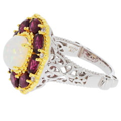 Elegant white opal sterling silver ring with ruby accents and intricate design, perfect for sophisticated jewelry collections.