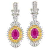 Elegant oval red ruby earrings with moissanite accents set in sterling silver, perfect for a luxurious style.