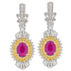Elegant oval red ruby earrings with moissanite accents set in sterling silver, perfect for a luxurious style.